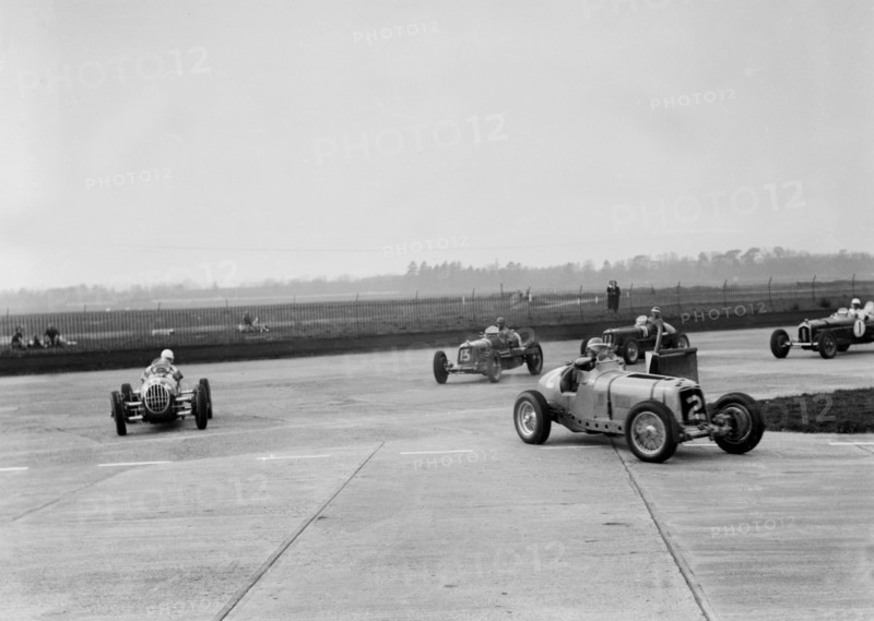 Racing cars taking a corner at Brooklands, Surrey, c1930s. Artist: Bill Brunell.