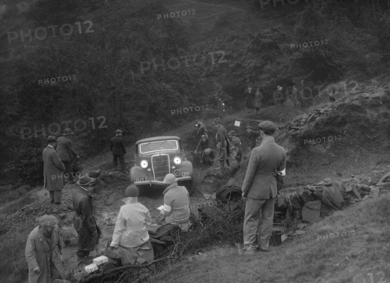 Ford V8 drop head coupe of GM Denton competing in the MCC Sporting Trial, 1935. Artist: Bill Brunell.