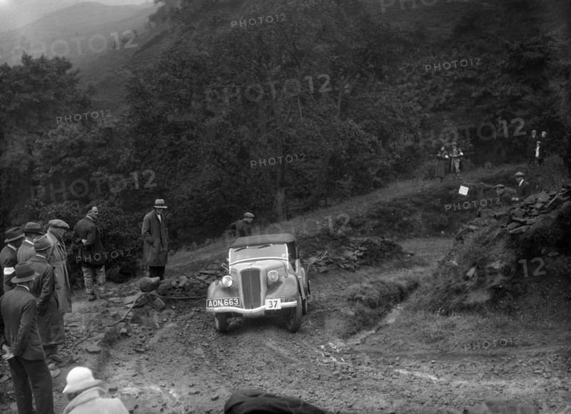 Ford 10 tourer of J Harrison competing in the MCC Sporting Trial, 1935. Artist: Bill Brunell.