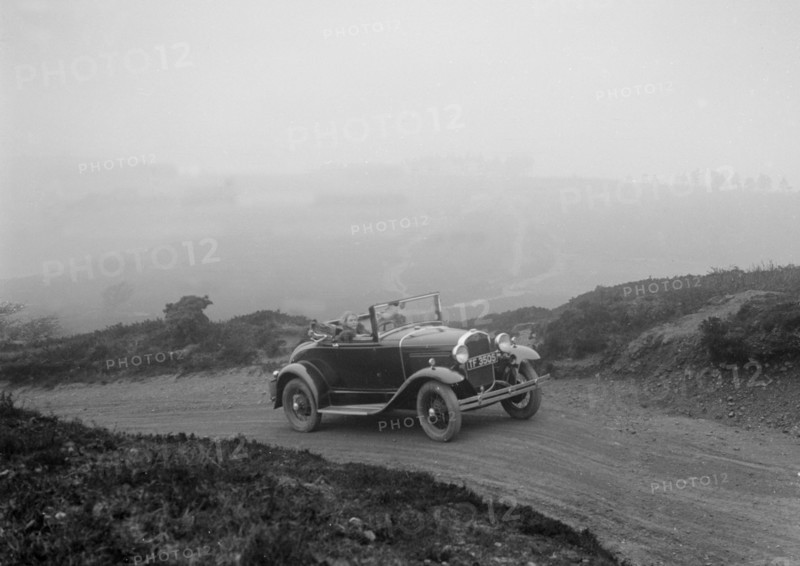 Kitty Brunell driving a 1930 2-seater Ford Model A, 1931.   Artist: Bill Brunell.