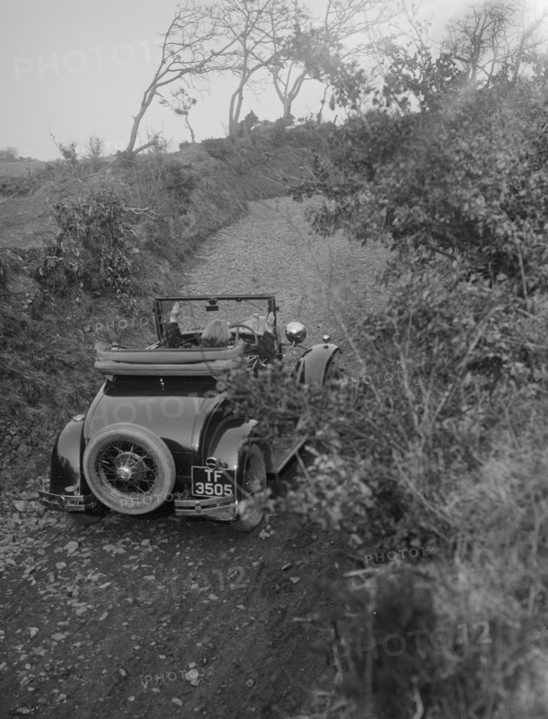 Kitty Brunell driving a 1930 2-seater Ford Model A, 1931.   Artist: Bill Brunell.