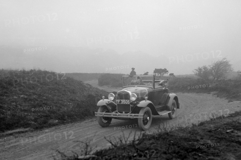 Kitty Brunell driving a 1930 2-seater Ford Model A, 1931.   Artist: Bill Brunell.