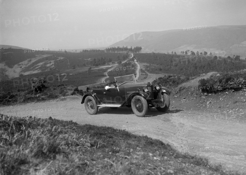 Kitty Brunell road testing a Riley 9 WD tourer, c1930. Artist: Bill Brunell.