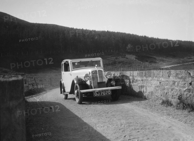 Austin Ten-Four 2-door saloon of JA Flewitt competing in the RSAC Scottish Rally, 1933. Artist: Bill Brunell.
