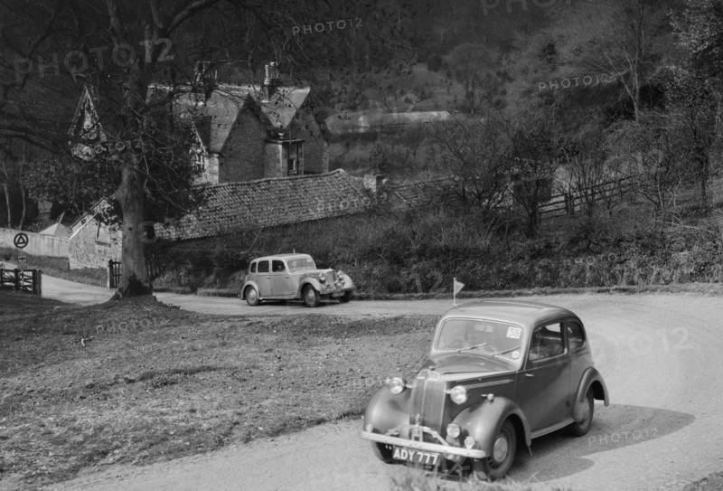 Vauxhall 10 of Miss IM Burton amd Rover of CG Dunham competing in the RAC Rally, 1939. Artist: Bill Brunell.