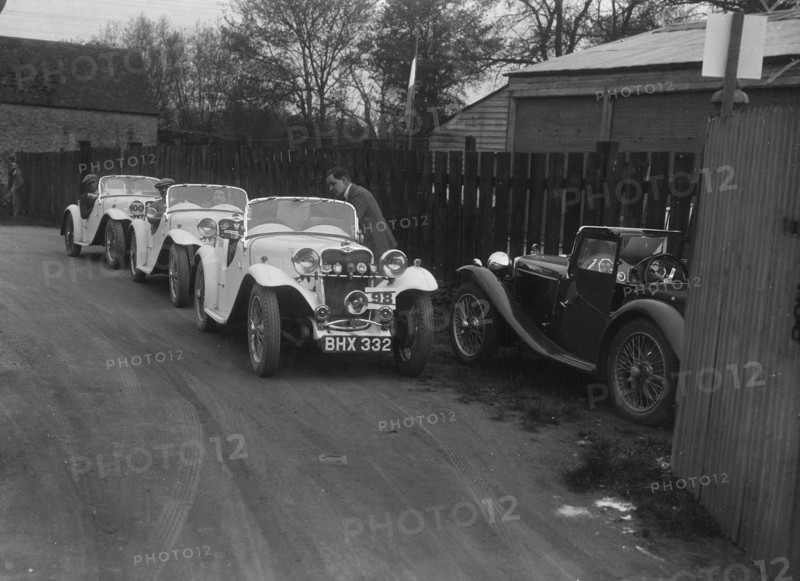 Three Singer cars and a MG PA at a motoring trial, 1930s. Artist: Bill Brunell.