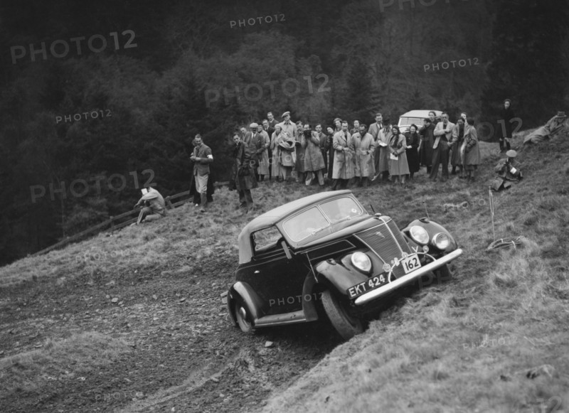 Ford V8 of J Cleland competing in the MCC Edinburgh Trial, Roxburghshire, Scotland, 1938. Artist: Bill Brunell.