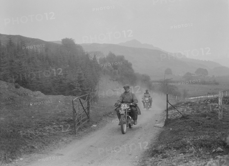 493 cc Triumphs of L Crisp and KP Jones competing in E&DMC Scottish 6 Days Trial, 1933.. Artist: Bill Brunell.