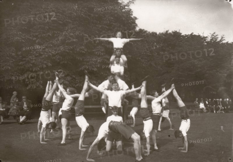 Boys pose in an outdoor gym lesson, 1929. Artist: Unknown
