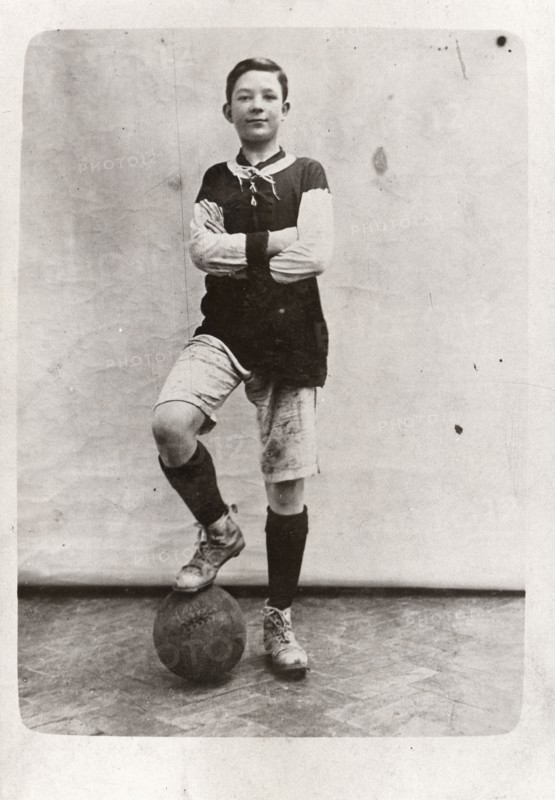 A boy poses in football kit, 1910. Artist: Unknown
