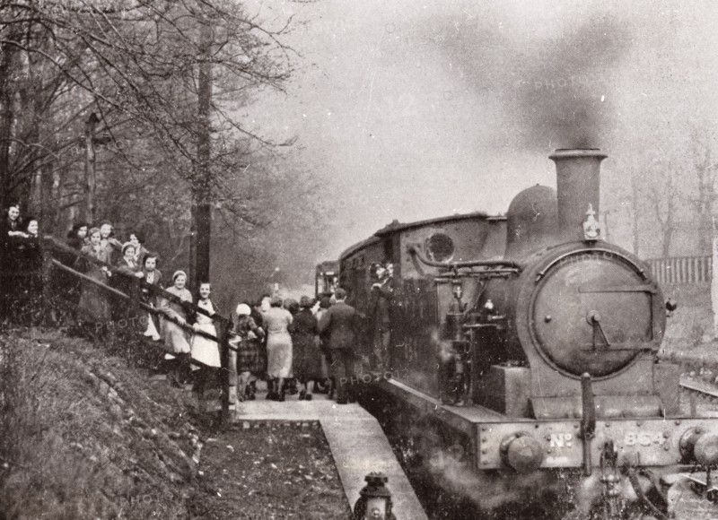 Passengers queuing for a steam rain at Rowntree's halt, York, Yorkshire, 1934. Artist: Unknown