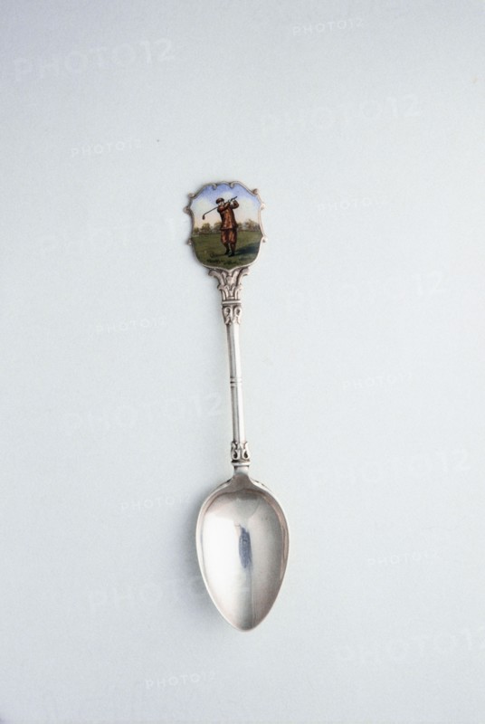 Silver spoon with enamelled shield with golfing theme, London, 1918. Artist: Unknown