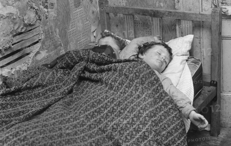 Children asleep in a slum dwelling in London's East End, 1965. Artist: Unknown