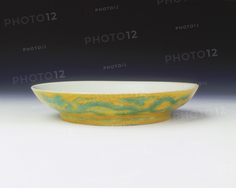 Yellow saucer with dragons in green enamel, Zhengde period, Ming dynasty, China, 1506-1521. Artist: Unknown