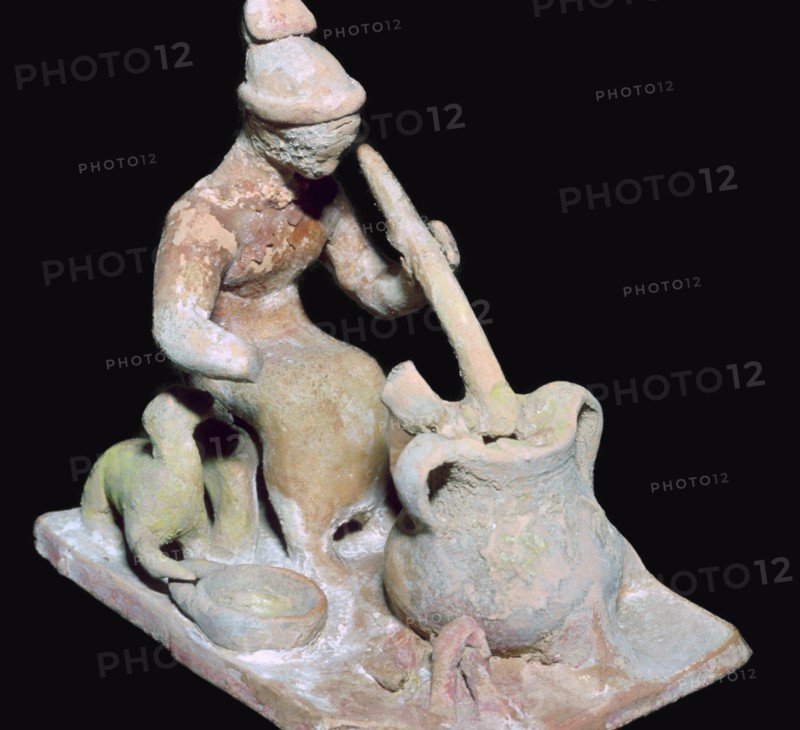 Greek terracotta statuette of a woman cooking. Artist: Unknown