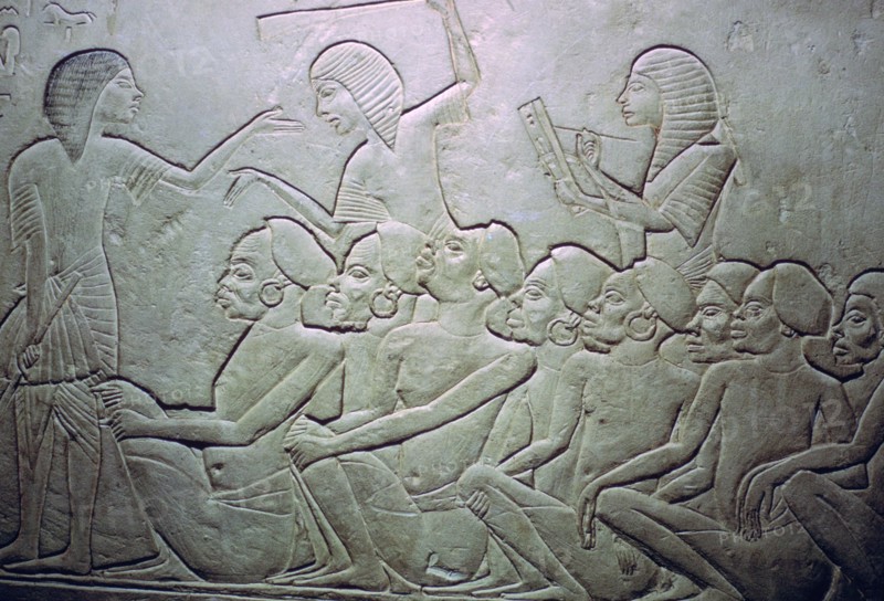Detail of an Egyptian stele showing an overseer, slaves and scribe. Artist: Unknown