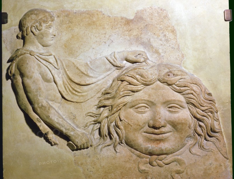 Roman fragment of a terracotta Campana relief showing head of Medusa with figure of Perseus. Artist: Unknown
