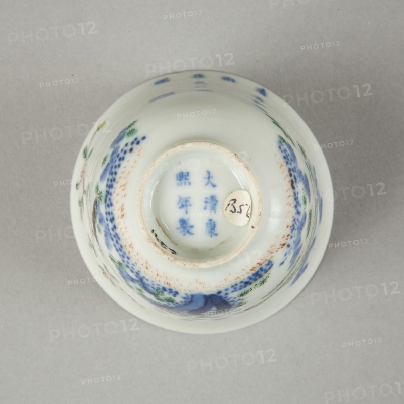 Underglaze blue month cup with polychrome enamelled decoration of a prunus tree. Artist: Unknown.