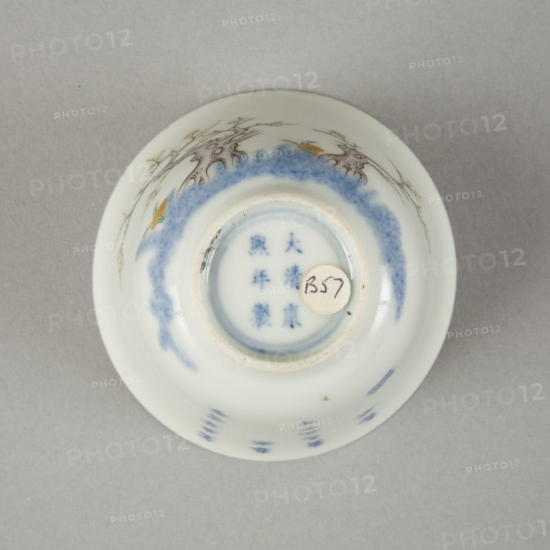 Underglaze blue month cup with polychrome enamelled decoration of a prunus tree. Artist: Unknown.