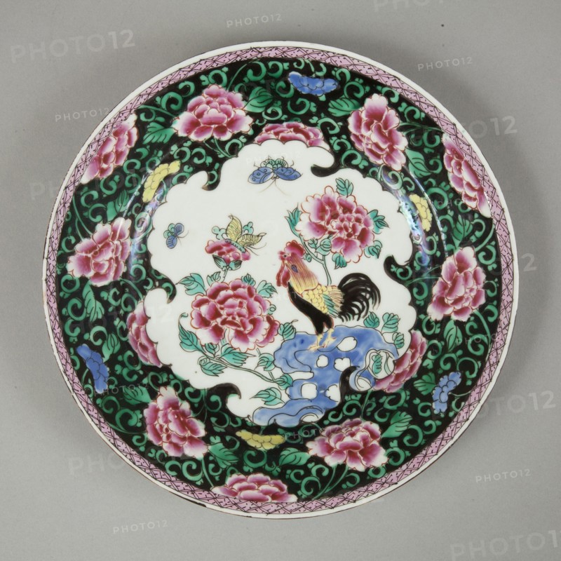 European copy of famille noire plate with cockerel looking at a butterfly, 20th century. Artist: Unknown.