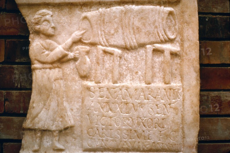 Roman relief, a woman draws wine from a cask at a Tavern, Merida, Spain, c2nd-3rd century. Artist: Unknown.