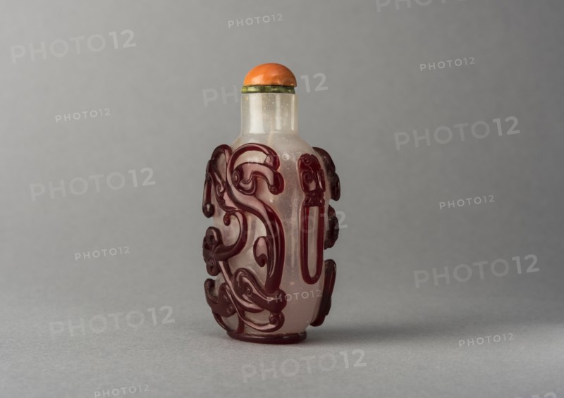 Clear glass snuff bottle with red overlay, China, Qing dynasty, 1644-1911. Creator: Unknown.
