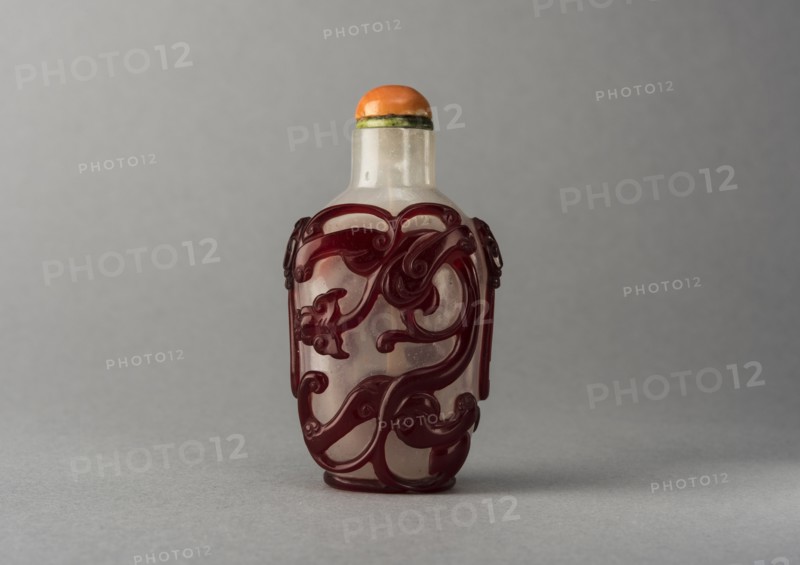 Clear glass snuff bottle with red overlay, China, Qing dynasty, 1644-1911. Creator: Unknown.