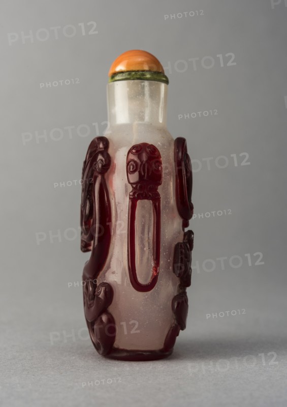 Clear glass snuff bottle with red overlay, China, Qing dynasty, 1644-1911. Creator: Unknown.