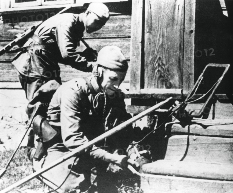 Russian soldiers with mine detectors clearing a booby-trapped house, Eastern Front, 1944. Artist: Unknown