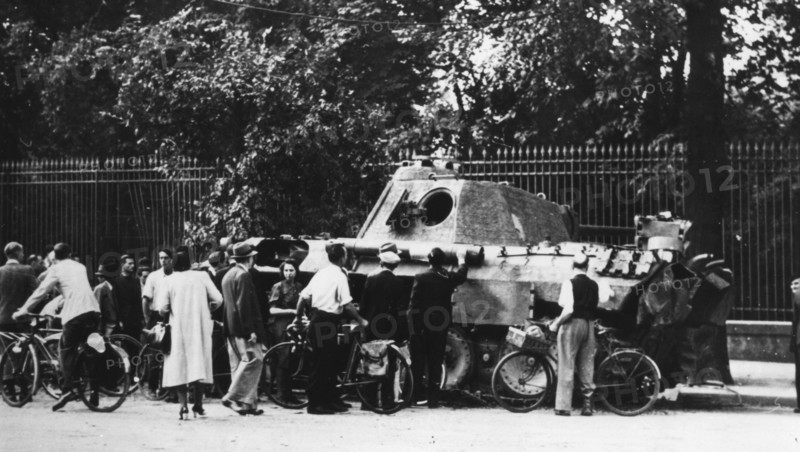Bystanders examining an abandoned tank on the Rue de Medicis, liberation of Paris, August 1944. Artist: Unknown