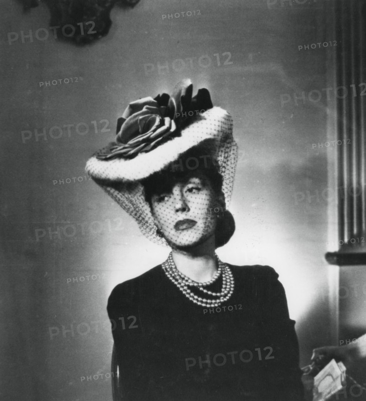 Woman wearing a hat and veil by the French fashion designer Jacques Fath, France, 1943. Artist: Unknown