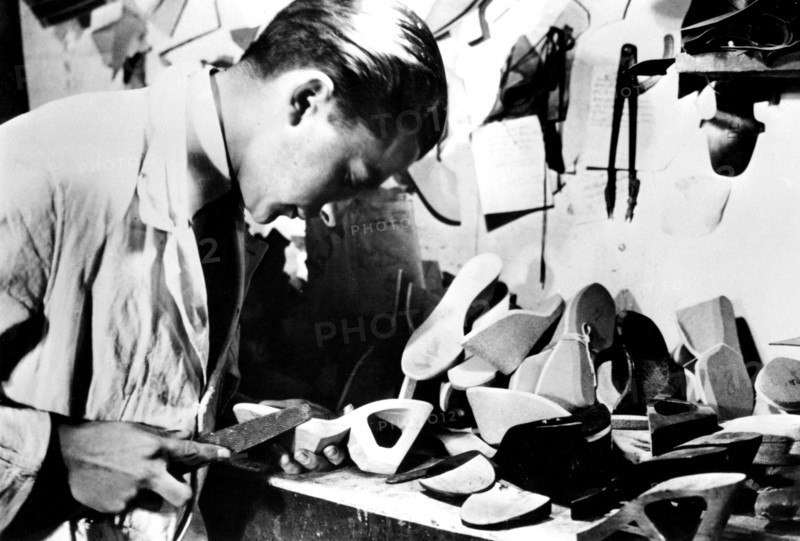 Making wooden shoe soles, German-occupied Paris, February 1941. Artist: Unknown