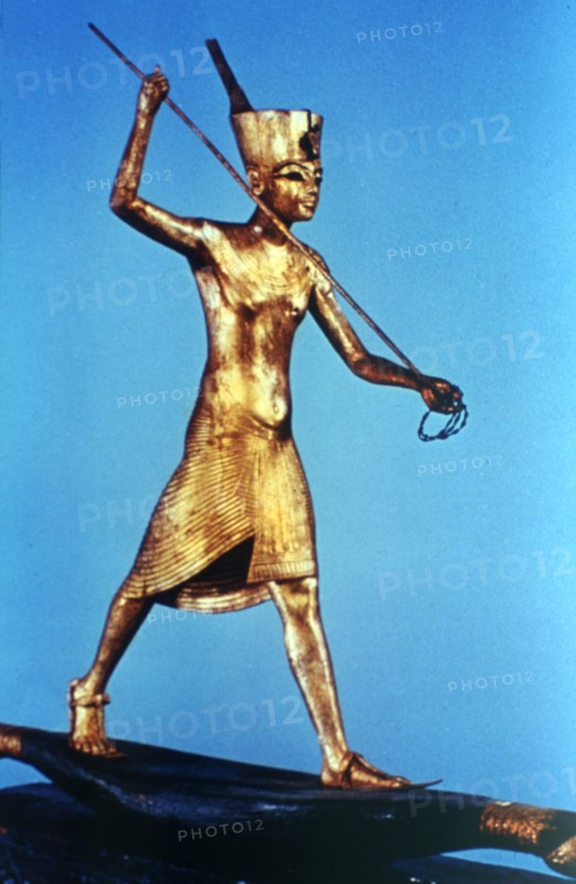 Gold figure of King Tutankhamun standing on a reed boat and spearing fish, 14th century BC. Artist: Unknown