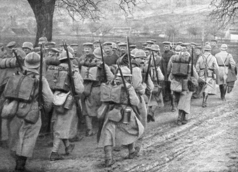 Relief French infantry passing a line of prisoners, Plessis-de-Roye, Picardy, France, 30 March 1918. Artist: Unknown