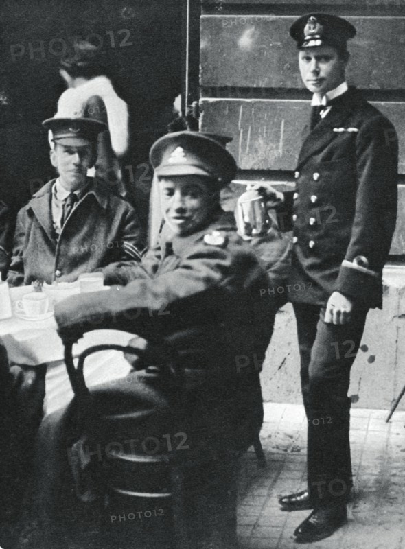 Sub-Lieutenant Prince Albert serving tea to wounded soldiers at Buckingham Palace, 1916. Artist: Unknown