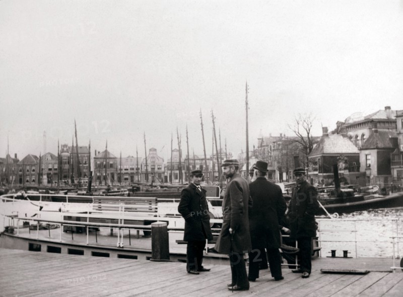 Men by a canal boat, Rotterdam, 1898.Artist: James Batkin