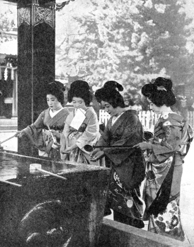 Japanese women washing their hands prior to entering a temple, 1936.Artist: Sport & General