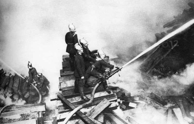 Firemen fighting a fire at a timber yard, London, 1926-1927. Artist: Unknown