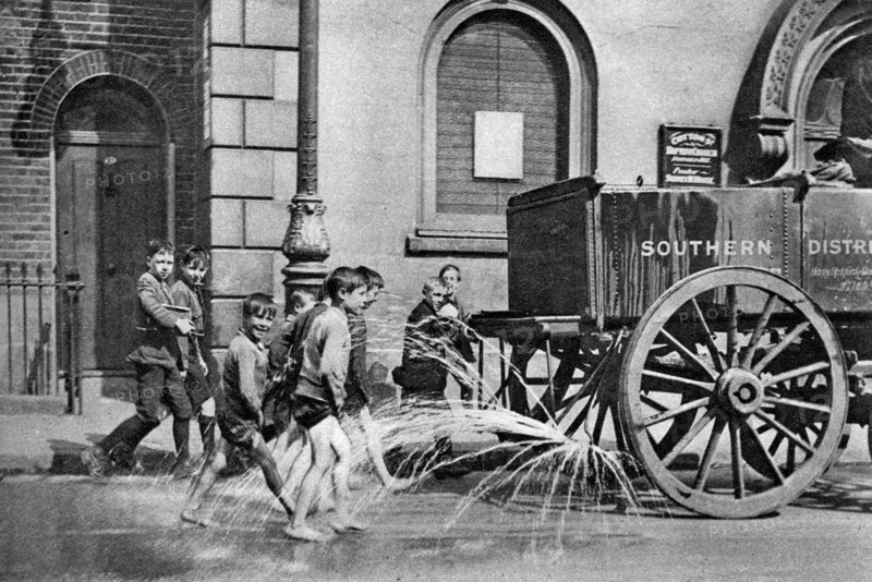 Boys following the Poplar Borough Council water cart, London, 1926-1927. Artist: Unknown