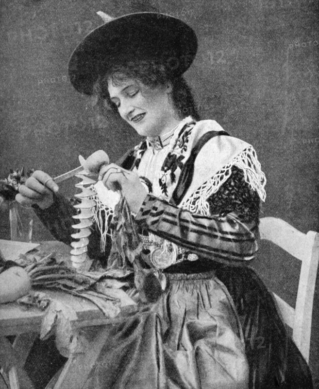 A woman creatively peeling a potato, 1922. Creator: Georg Haeckel.