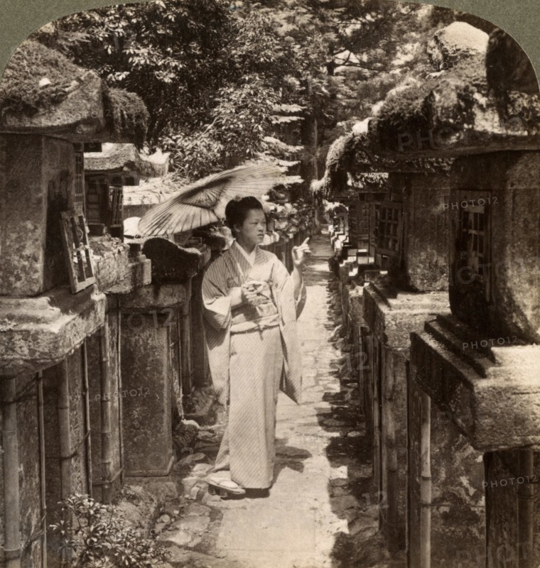 A woman Shinto devotee counting the stone lanterns, Kasuga Shrine, Nara, Japan, 1904.Artist: Underwood & Underwood