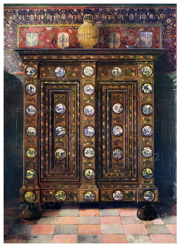 Walnut kas inlaid and with painted medallions of Delft ware, 1910.Artist: Edwin Foley