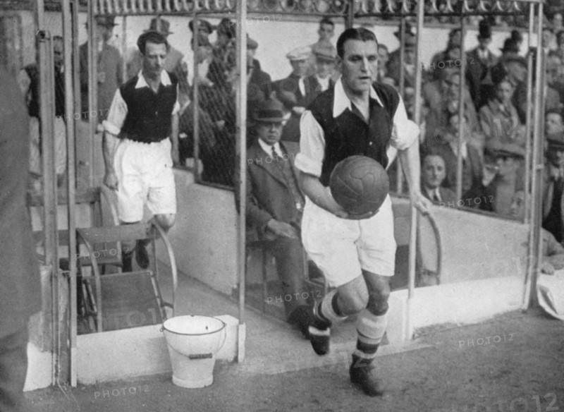 Arsenal FC captain Eddie Hapgood runs onto the pitch at Highbury, London, 1930s. Artist: Barratt's Photo Press Ltd