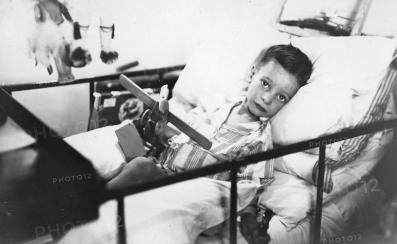 Greek boy from Pylos being nursed in the sick bay of the British battleship HMS 'Malaya', 1938. Artist: Unknown