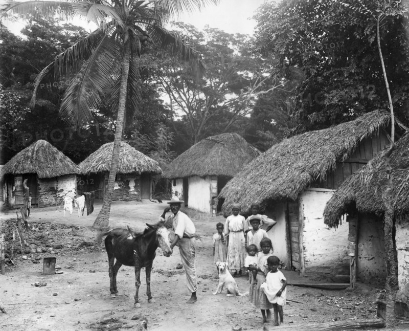 Family outside their home, Coolie Street, Kingston, Jamaica, 1931. Artist: Unknown
