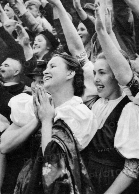 Admiring crowd saluting German Nazi leader Adolf Hitler, 1938. Artist: Unknown