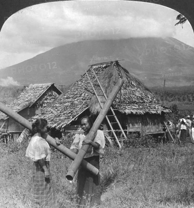 Native girls with their water vessels made from shafts of bamboo, Philippines, 1907. Artist: HC White