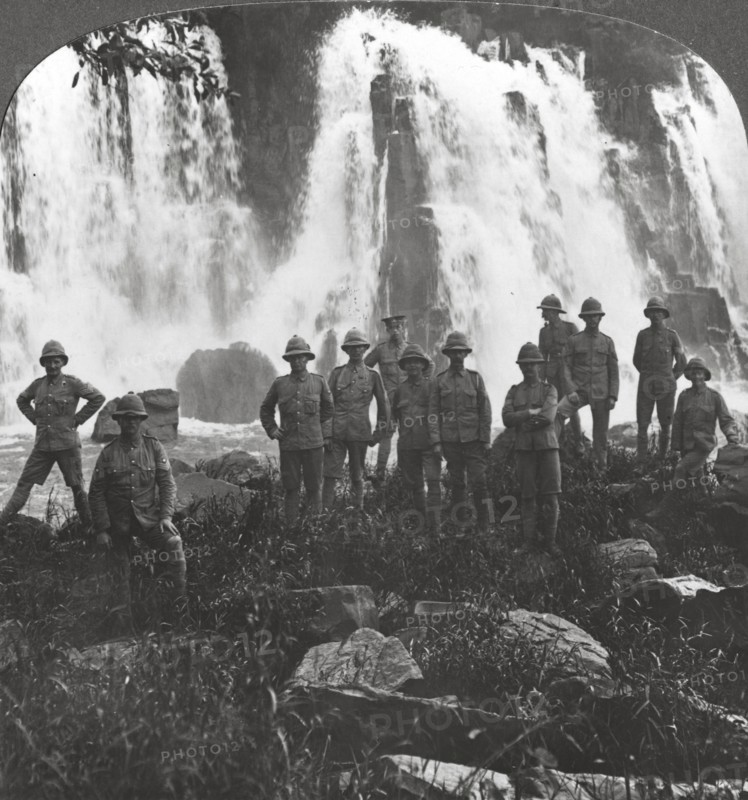British troops refreshing themselves at a waterfall, Africa, World War I, c1914-c1918. Artist: Realistic Travels Publishers