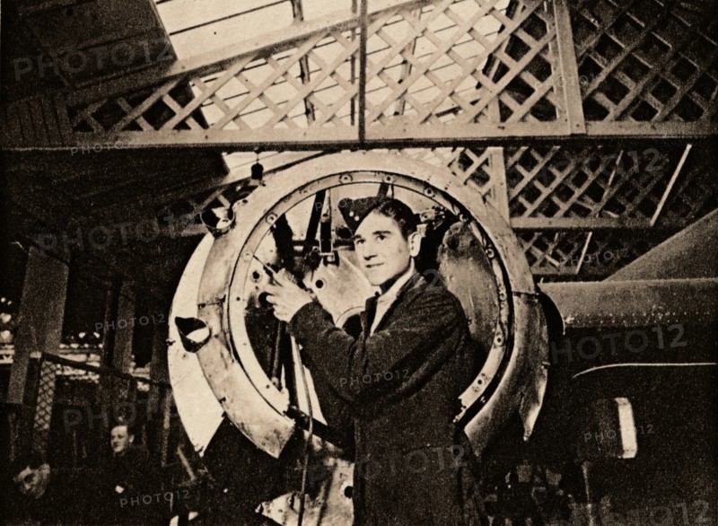 A metal worker with automatic drill stripping an engine casing, 1940. Artist: Unknown