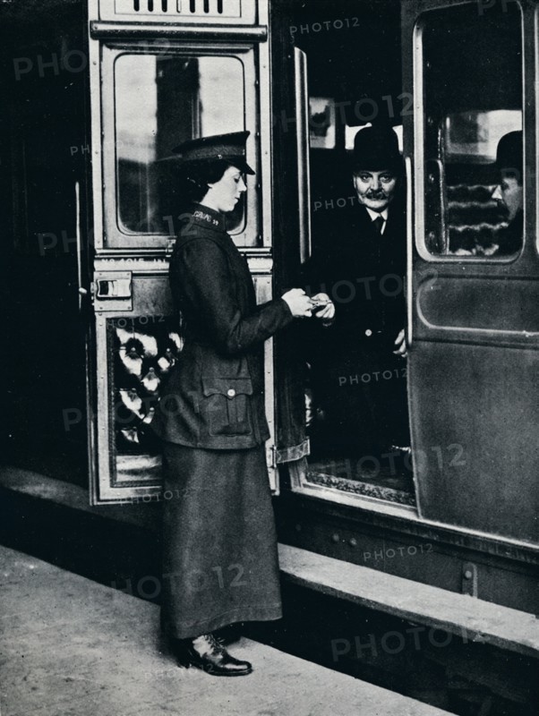A woman ticket inspector at work, c1914. Artist: Unknown
